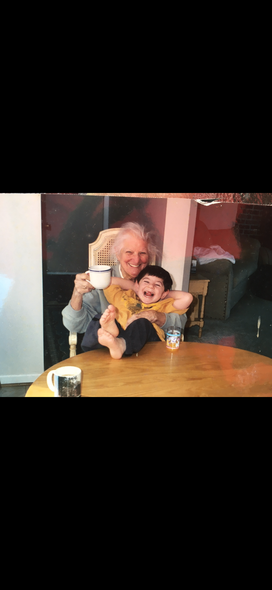 Michelle's grandmother laughing with a young grandchild